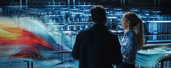 Two workers inside a data centre